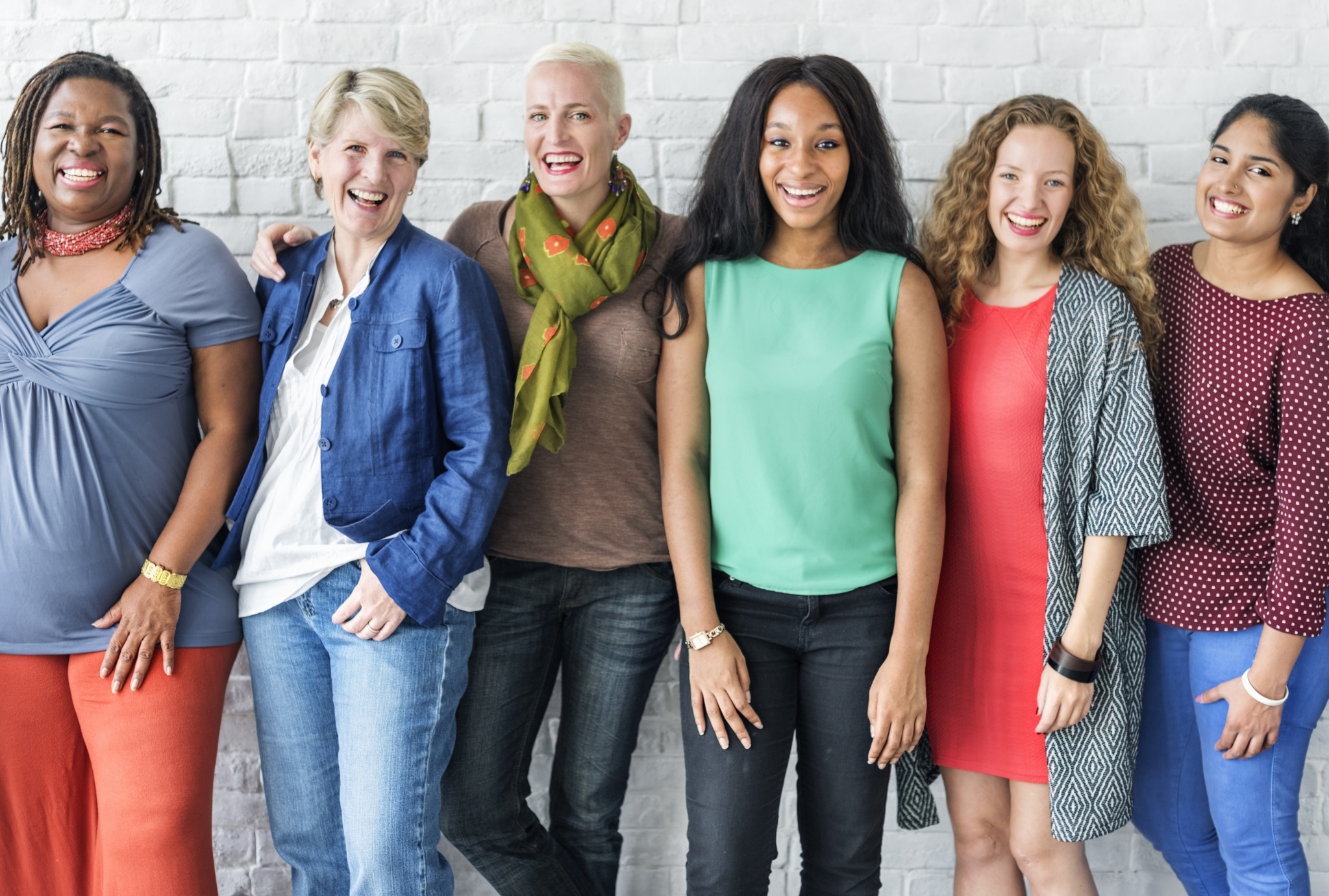 A diverse group of women smiling together